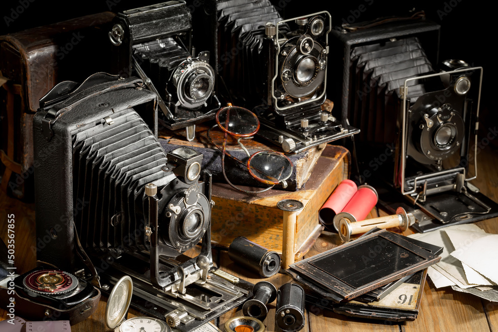 Old camera in the studio on an old background Old camera in the studio on an old background