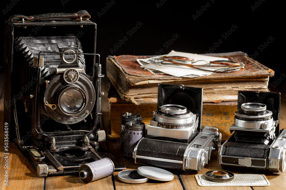 Old vintage cameras on an old background.