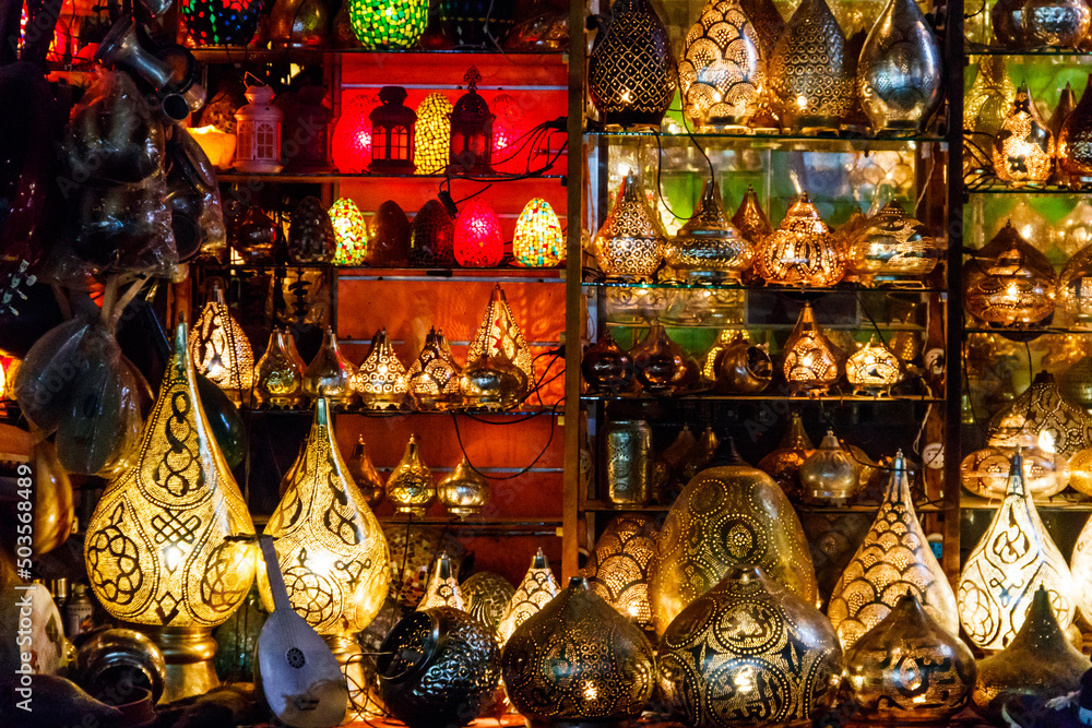 Fototapeta premium Electric luminous colorful mosaic lamps in oriental style as tourist souvenirs at night street market in Sharm El Sheikh, Egypt
