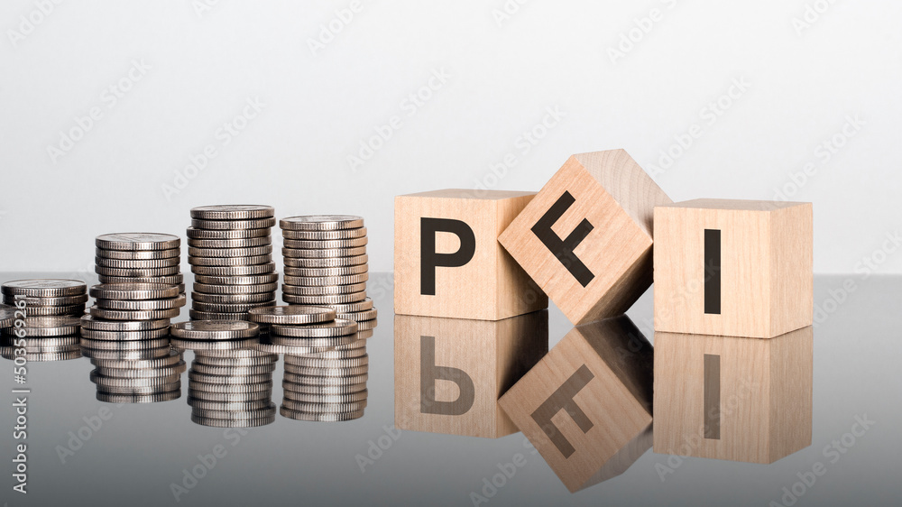 PFI - text is made up of letters on wooden cubes lying on a mirror surface PFI - text is made up of letters on wooden cubes lying on a mirror surface