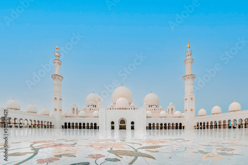 Exterior photo of the beautiful Sheikh Zayed Mosque with its massive courtyard in Abu Dhabi, United Arab Emirates 