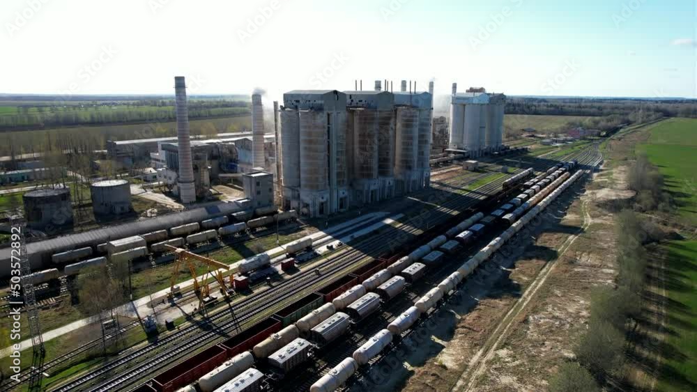 Smoke from pipes of cement plant. Сement Factory with smoke pipe. Chimney smokestack emission. Cement freight cars on railway. Transport bulk materials on railroad. Tank cars near industrial plant.
Smoke from pipes of cement plant. Сement Factory with smoke pipe. Chimney smokestack emission. Cement freight cars on railway. Transport bulk materials on railroad. Tank cars near industrial plant.