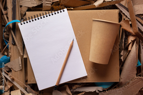 Recycling concept and waste paper heap. Cup and product from recycled paper