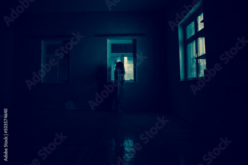 Horror woman in window wood hand hold cage scary scene halloween concept Blurred silhouette of witch. Horror theme