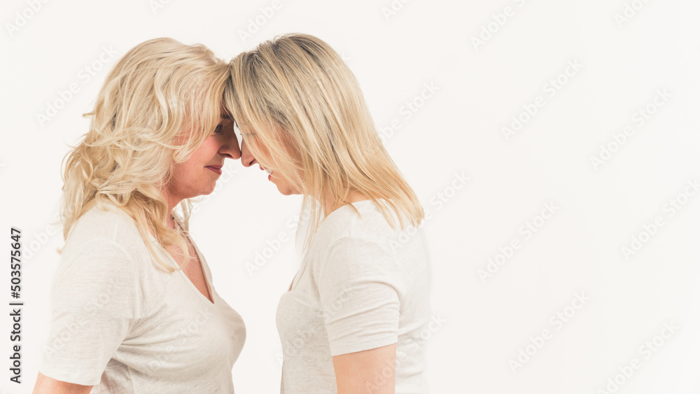 mom and daughter looking on each other on the white background, isolated, copyspace. High quality photo mom and daughter looking on each other on the white background, isolated, copyspace. High quality photo
