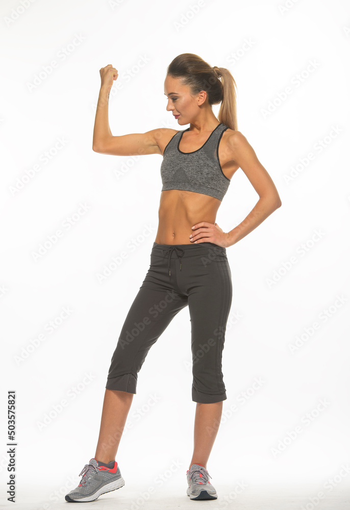 athletic girl in training clothes posing on a white background in the studio in full growth
athletic girl in training clothes posing on a white background in the studio in full growth