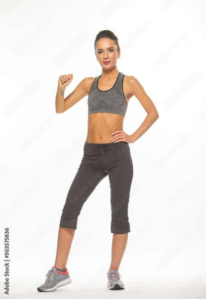 athletic girl in training clothes posing on a white background in the studio in full growth
athletic girl in training clothes posing on a white background in the studio in full growth