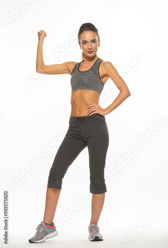 athletic girl in training clothes posing on a white background in the studio in full growth 