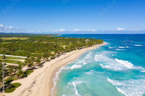 Caribbean beach scene with coconut palms, sand, ocean and blue sky. Tropical nature. Dominican Republic. Aerial view © photopixel