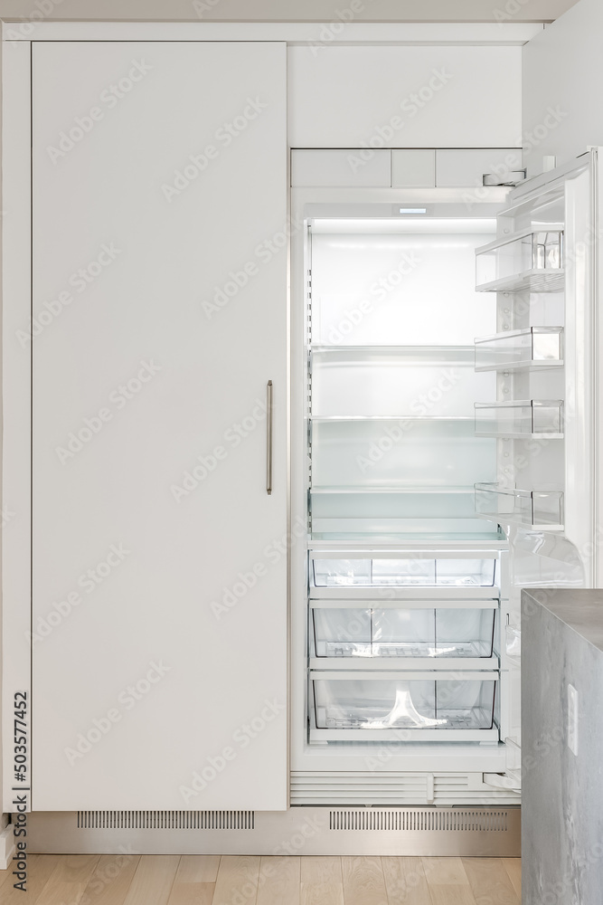 Modern White Kitchen. Custom built white refrigerator with double doors. Empty fridge for staging. Modern White Kitchen. Custom built white refrigerator with double doors. Empty fridge for staging.