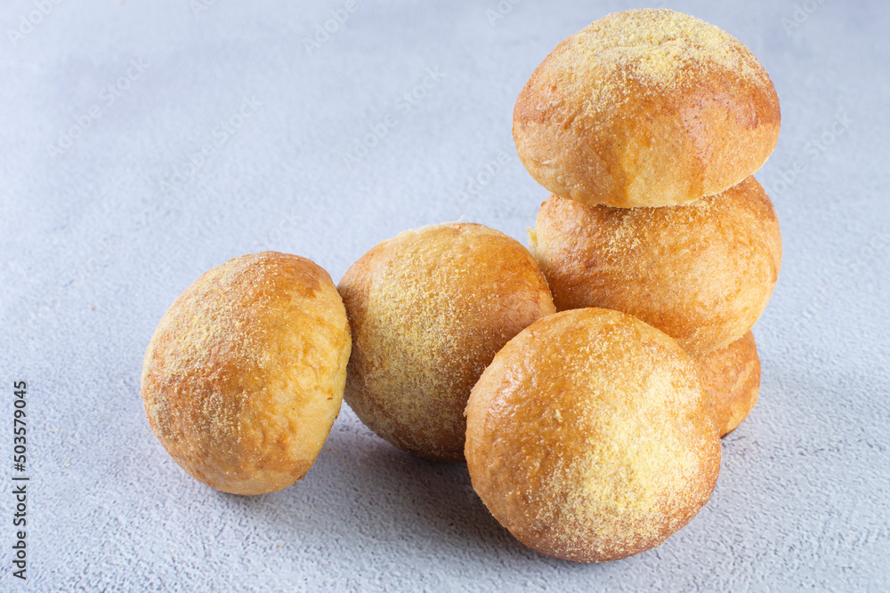 Corn and cheese bread, displayed on gray background Corn and cheese bread, displayed on gray background