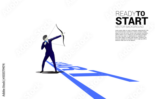 Businessman in suit shoot the arrow from start line. Concept of start business and ready to shoot.
