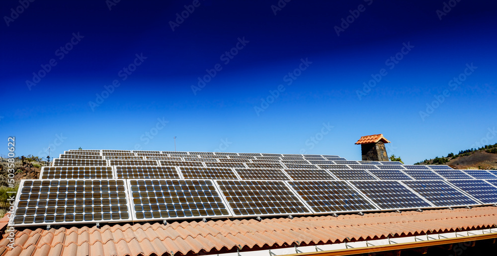 Small solar panels on the roof of a house in the sunny mountain. Small solar panels on the roof of a house in the sunny mountain.