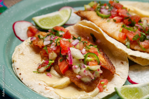 Fish tacos with fresh sauce and mayonnaise. Mexican food