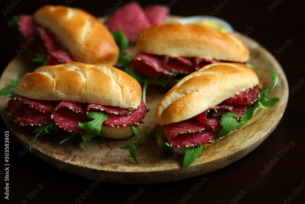 Selective focus. Salami sandwiches with herbs and mustard. Selective focus. Salami sandwiches with herbs and mustard.