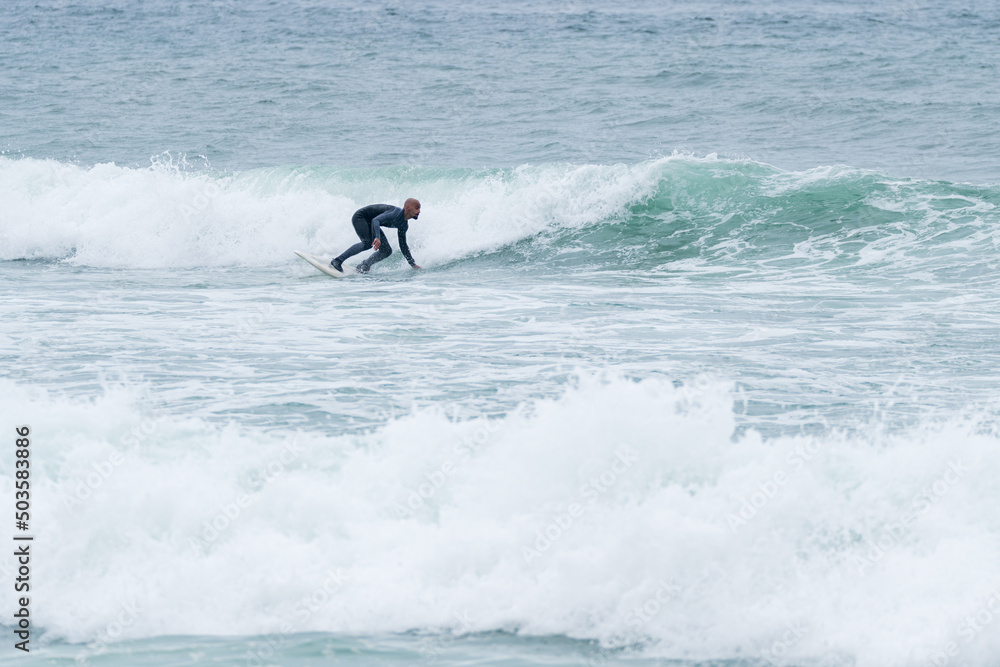 Surfer riding waves