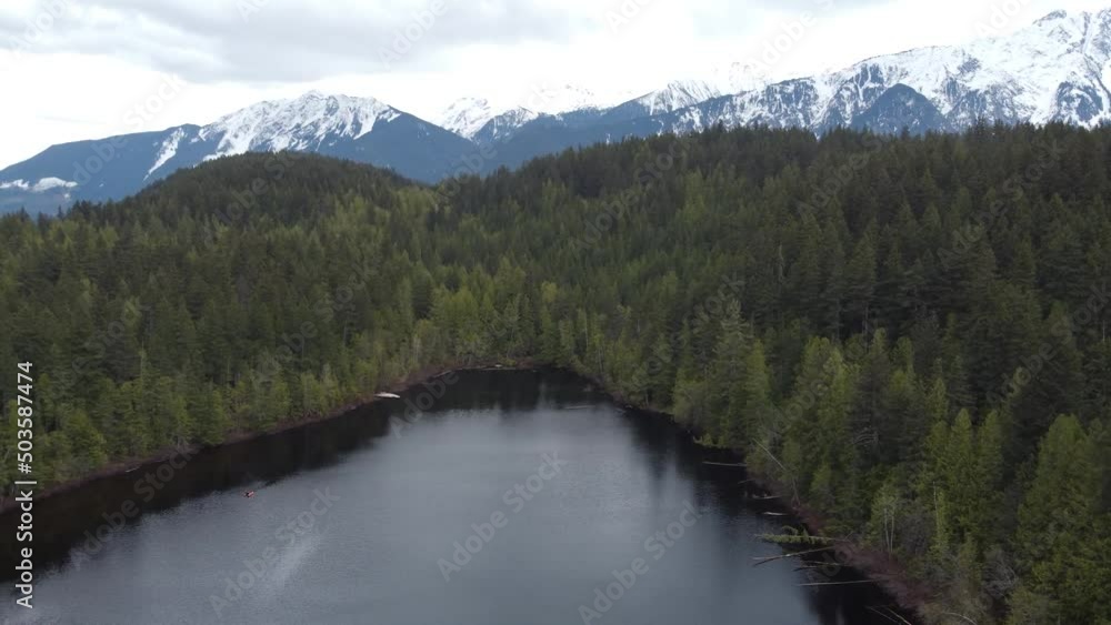 Lake aerial view with thick conifer and rock Lake aerial view with thick conifer and rock
