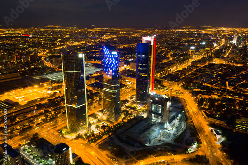 Night aerial view of modern Madrid cityscape with tallest skyscrapers of Four Towers Business Area, Spain