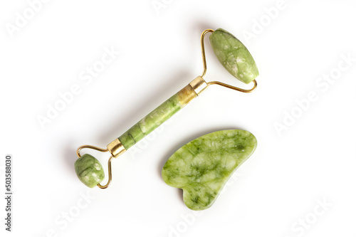 Fototapeta Naklejka Na Ścianę i Meble -  Facial massage tool. Green Quartz jade roller on white background. top view
