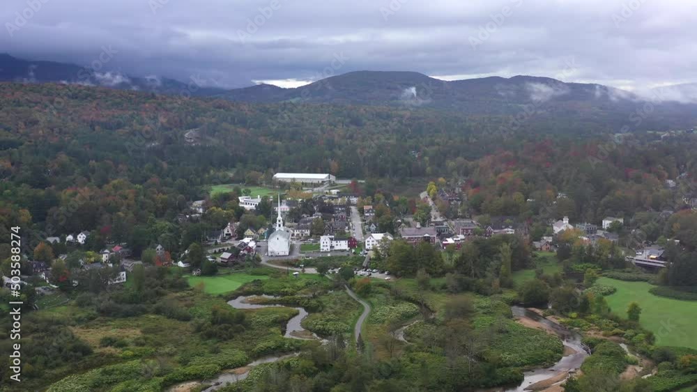 A beautiful view of a small town with a church, as you fly through clouds. A beautiful view of a small town with a church, as you fly through clouds.
