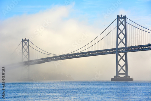 Fog surrounding the Oakland Bay Bridge in San Francisco, California photo
