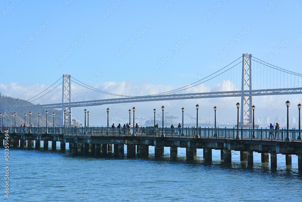 Pier with Oakland Bay Bridge in the background in San Francisco, California