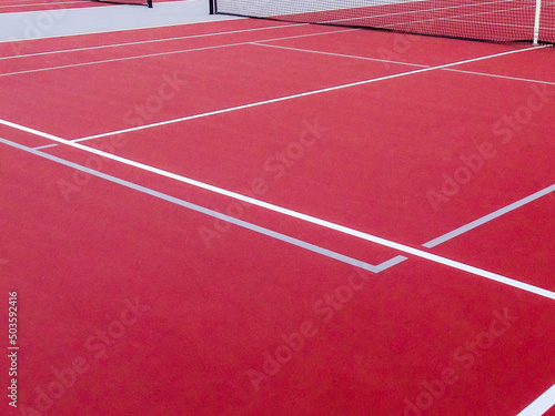 New red tennis courts with white lines and gray pickleball lines.