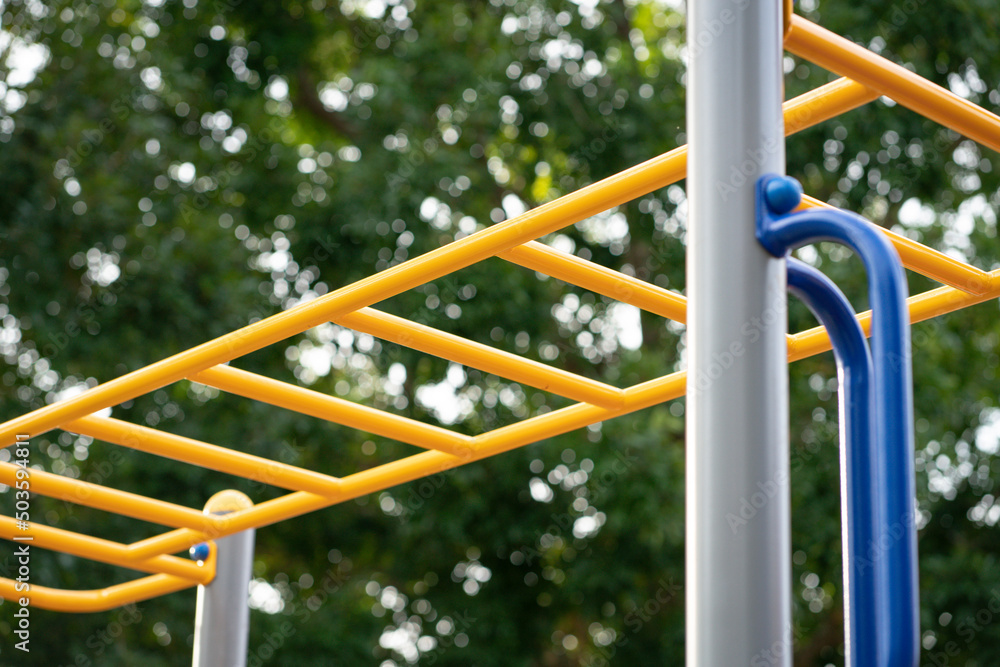 Yellow color monkey bars on a playground.
Yellow color monkey bars on a playground.