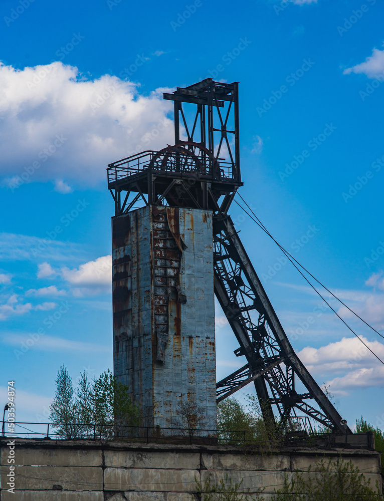 A coal mine coper against a cloudy sky A coal mine coper against a cloudy sky