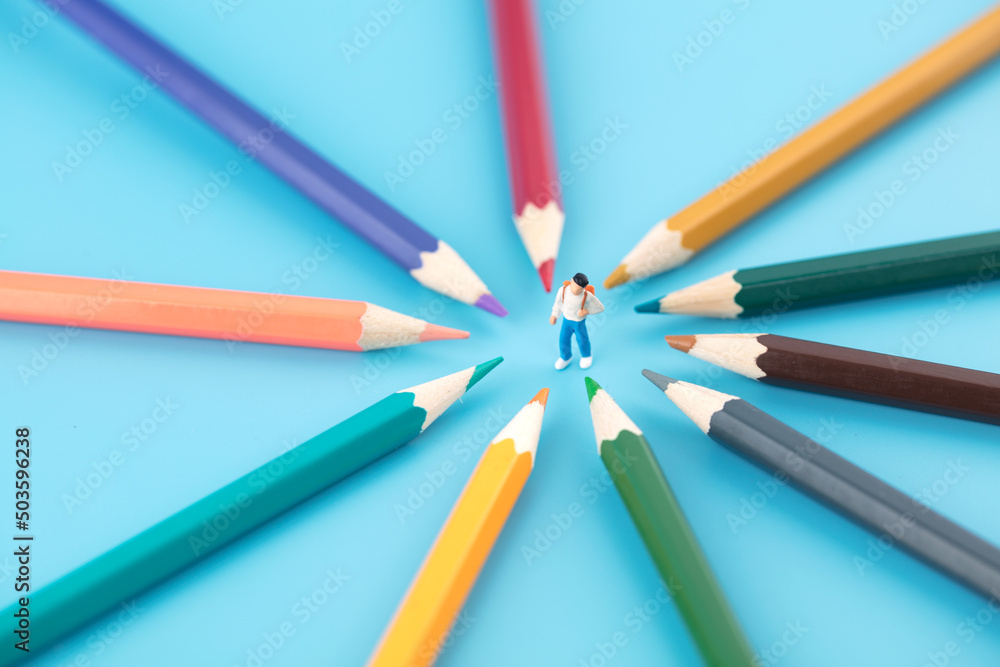 Miniature creative education concept pencils around schoolchildren Miniature creative education concept pencils around schoolchildren