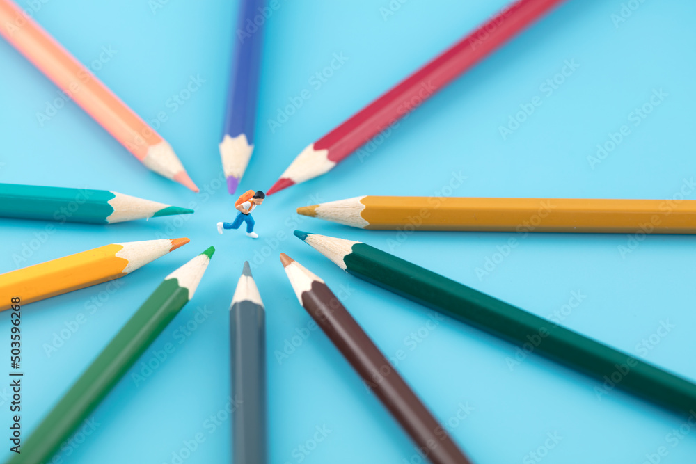 Miniature creative education concept pencils around schoolchildren