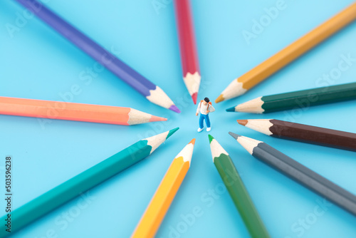 Miniature creative education concept pencils around schoolchildren