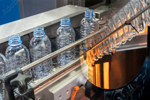 The abstract scene of plastic processing of PET bottles in the drinking water factory. photo