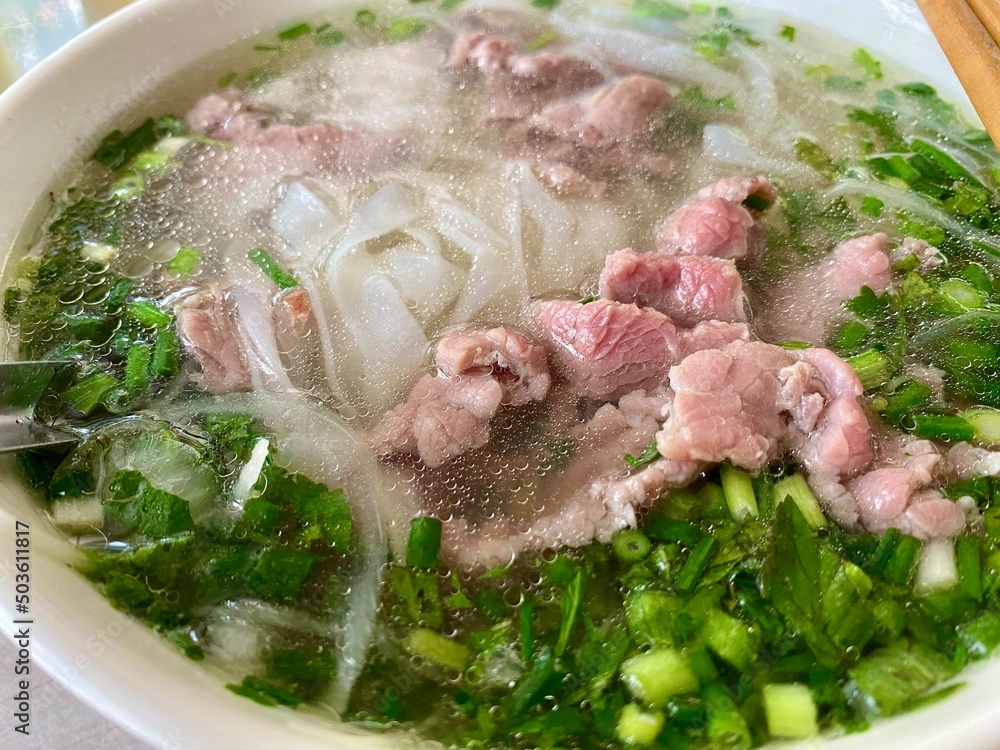 Pho bo - Vietnamese cuisine with beef, green onions, rice noodles, and rich broth. Usually served with herbs, lemon and chili Pho bo - Vietnamese cuisine with beef, green onions, rice noodles, and rich broth. Usually served with herbs, lemon and chili