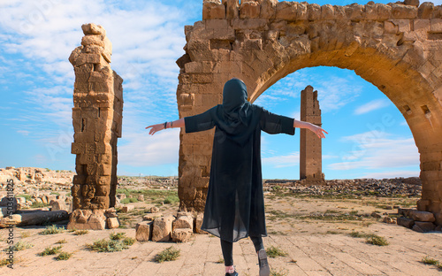 Beautiful girl arms up in traditional dress - Ruins of the ancient city of Harran - Urfa , Turkey (Mesopotamia) - Old astronomy tower