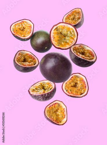 Delicious flying passion fruit on lilac background