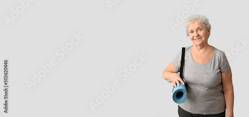 Elderly woman holding yoga ...