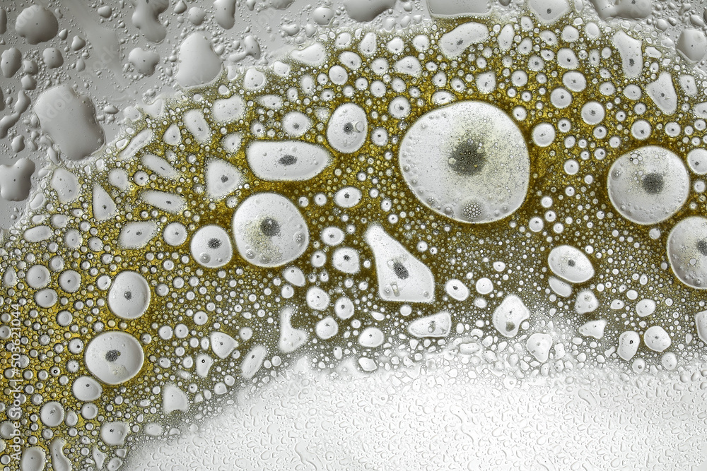 Essential oil drops on grey background, closeup Essential oil drops on grey background, closeup