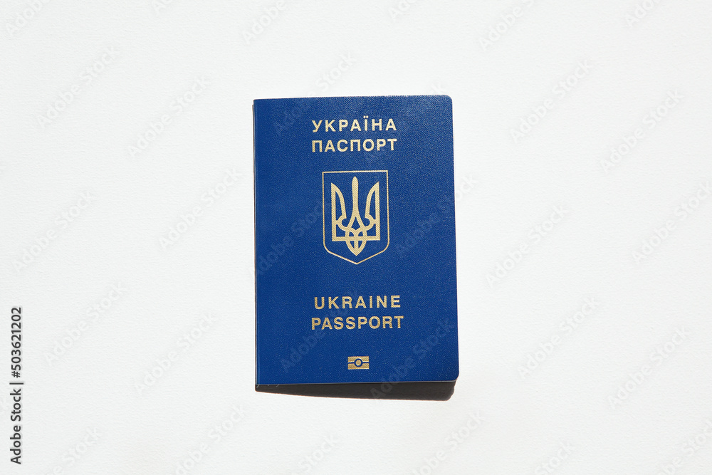 Ukrainian passport with golden trident symbol. Biometrical Ukraine passport id. Passport of citizen of Ukraine on white background, close-up, copy space. Inscription in Ukrainian and English Ukrainian passport with golden trident symbol. Biometrical Ukraine passport id. Passport of citizen of Ukraine on white background, close-up, copy space. Inscription in Ukrainian and English