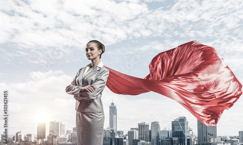 Concept of power and sucess with businesswoman superhero in big city