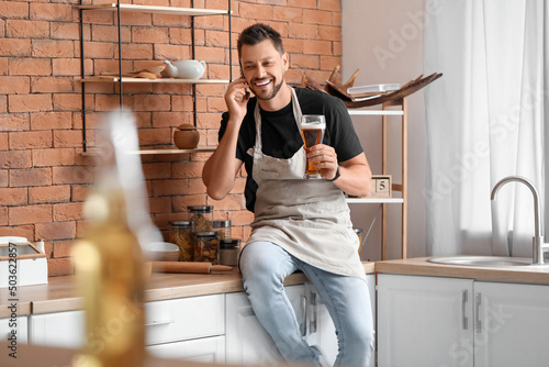 Handsome man drinking beer ...