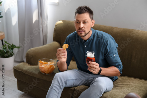 Handsome man drinking beer ...