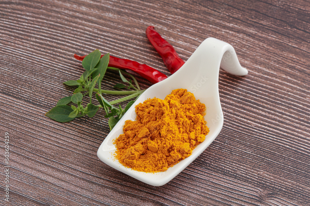 Yellow vibrant curcuma powder in the bowl Yellow vibrant curcuma powder in the bowl