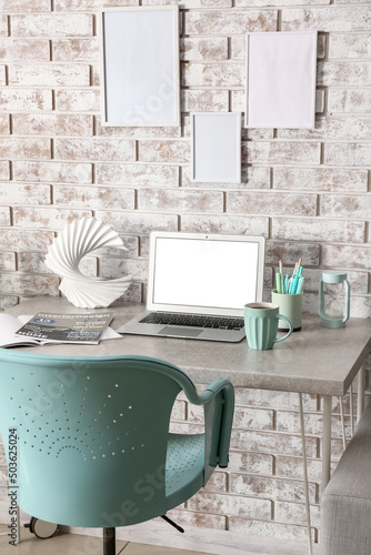 Workplace with modern lapto...