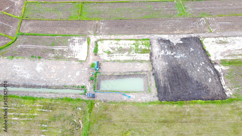 Aerial drone view of green fields and farmland.