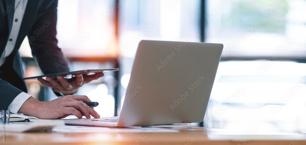 Executive businessman working on laptop computer at modern workspace. Executive businessman working on laptop computer at modern workspace.
