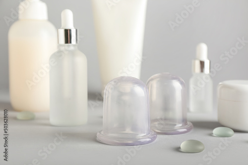Vacuum jars for anti-cellulite massage on light background