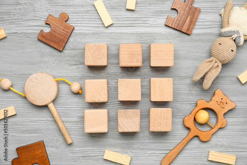 Cubes with baby toys on gre...