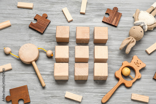 Cubes with baby toys on gre...