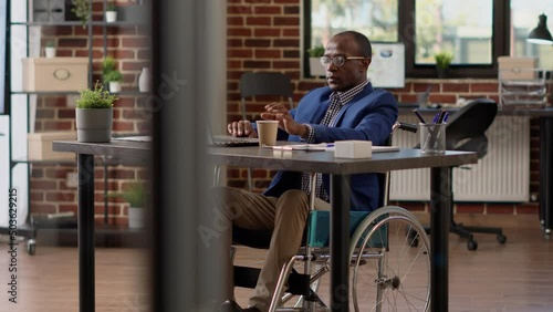 Wallpaper Mural Project manager creating report on laptop in disability friendly office, using wheelchair and suffering from physical impairment. Paralyzed businessman with chronic health condition at job. Torontodigital.ca